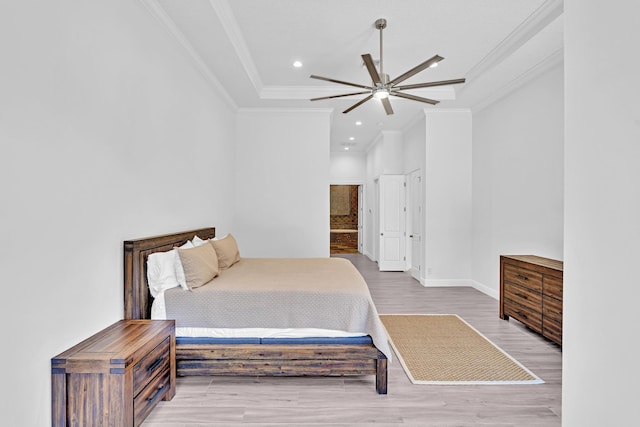 bedroom featuring ornamental molding, wood-type flooring, and ceiling fan