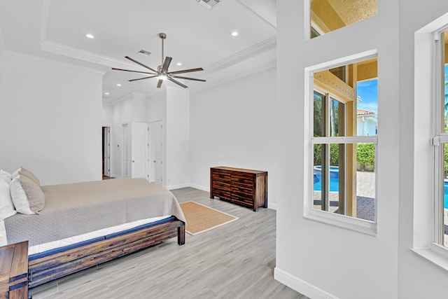 bedroom featuring light hardwood / wood-style flooring, ornamental molding, and ceiling fan