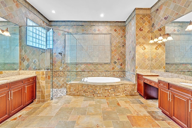 bathroom featuring vanity, tile walls, and separate shower and tub