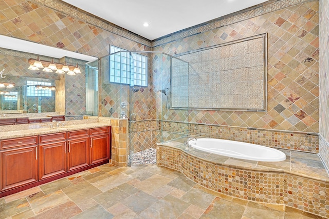 bathroom featuring vanity, tile walls, and separate shower and tub