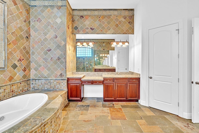 bathroom with vanity and tiled tub