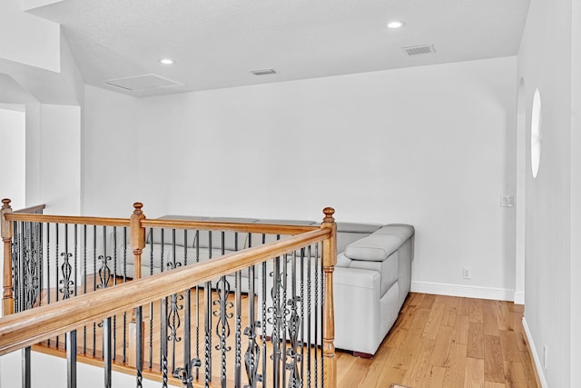 hallway featuring a textured ceiling and light wood-type flooring