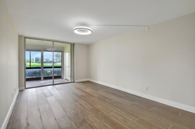 empty room with hardwood / wood-style floors