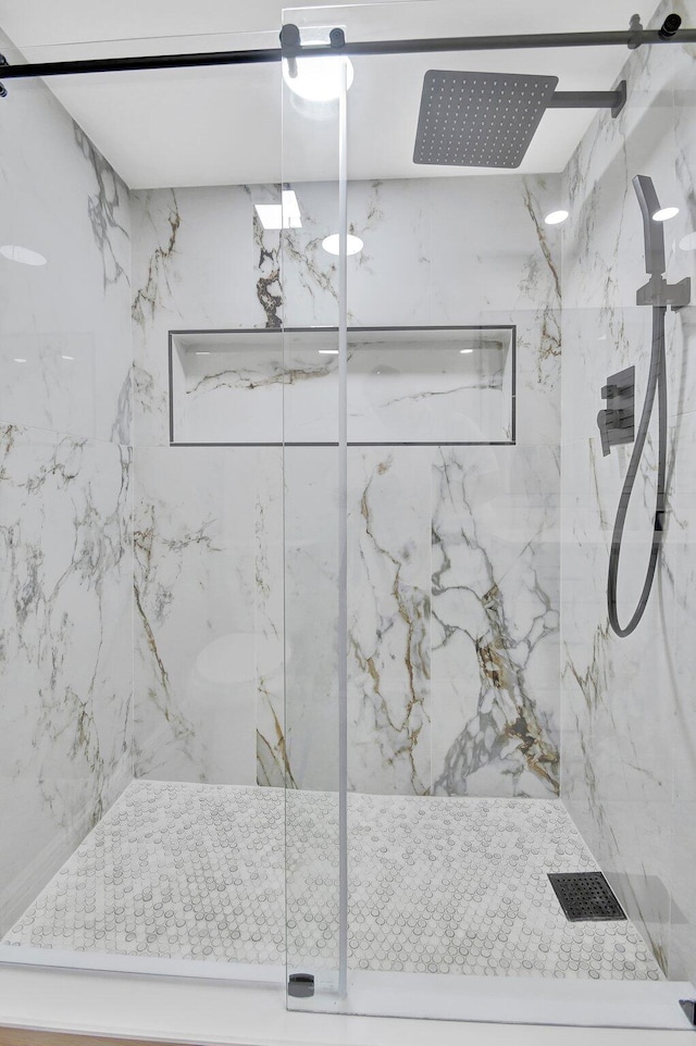 bathroom featuring a shower with shower door