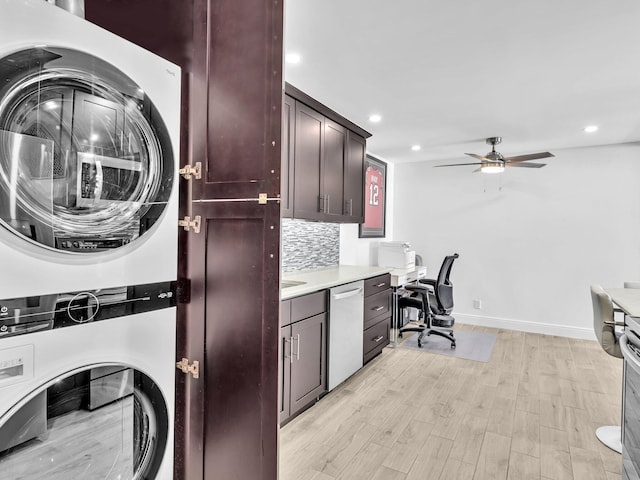 clothes washing area with stacked washer and dryer, ceiling fan, and light hardwood / wood-style floors