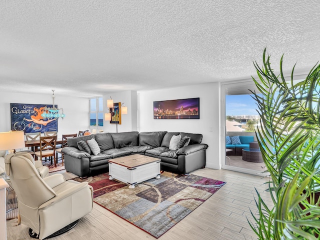 living room featuring light hardwood / wood-style floors and a textured ceiling