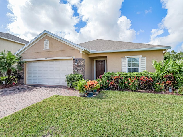 single story home featuring a garage and a front lawn