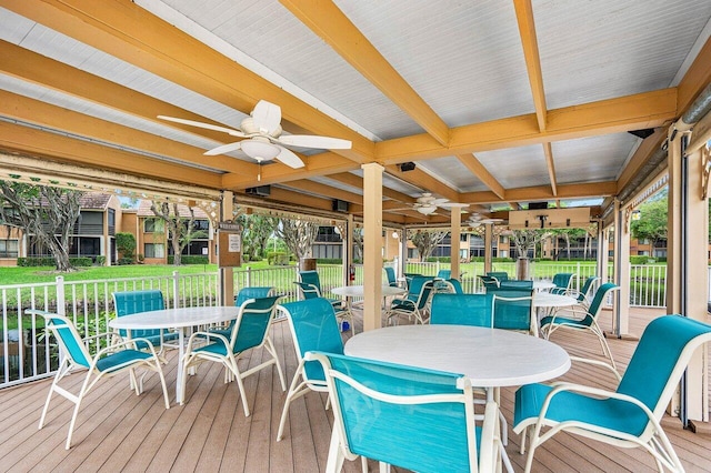 sunroom / solarium with beam ceiling and ceiling fan