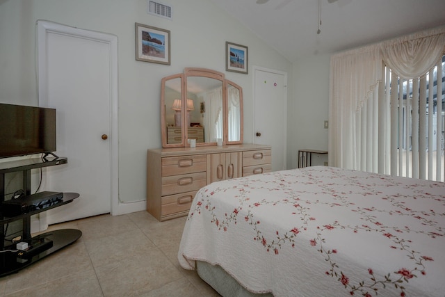 bedroom featuring lofted ceiling, visible vents, and light tile patterned flooring