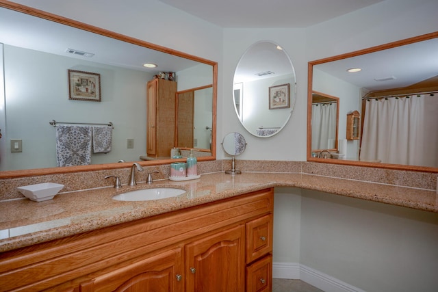 bathroom with recessed lighting, visible vents, and vanity