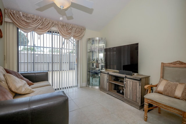 living room featuring vaulted ceiling, ceiling fan, and light tile patterned flooring