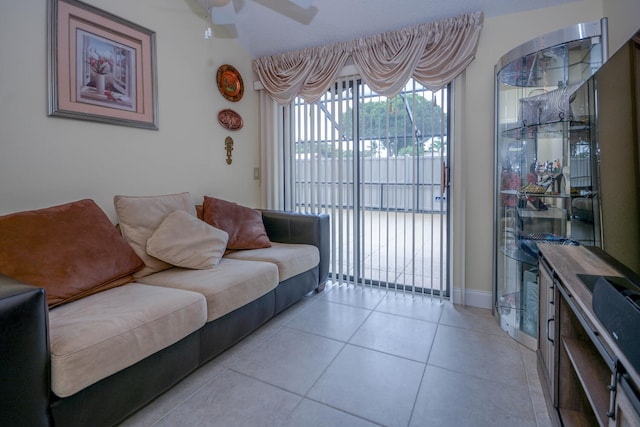 living area with ceiling fan and light tile patterned flooring