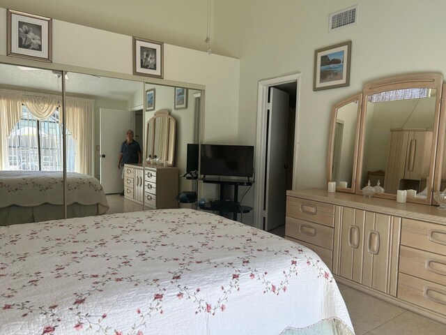 tiled bedroom featuring a closet