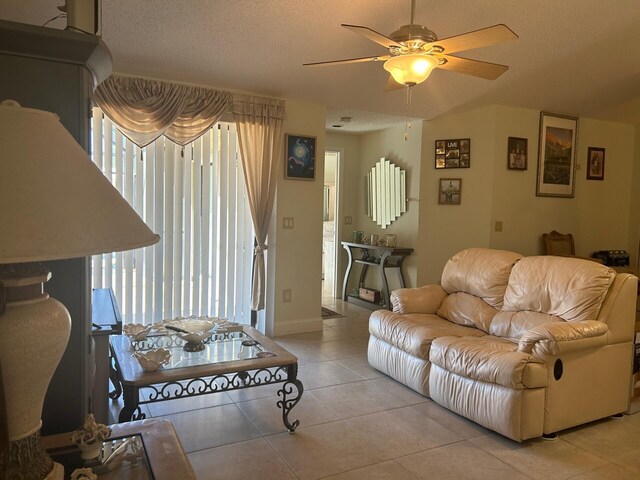 tiled living room featuring ceiling fan and a textured ceiling