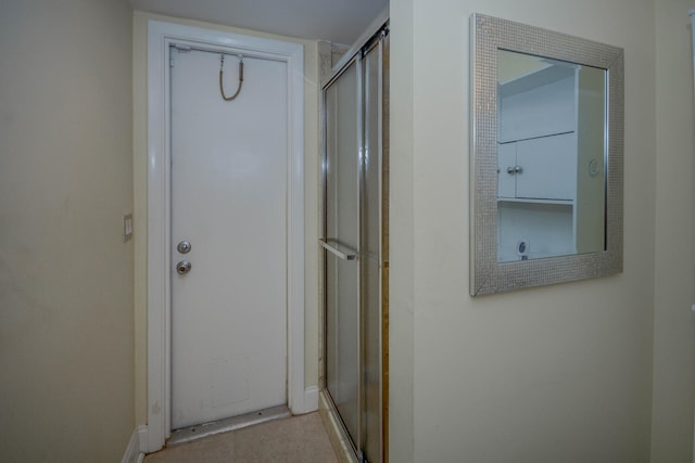 interior space featuring a shower with door