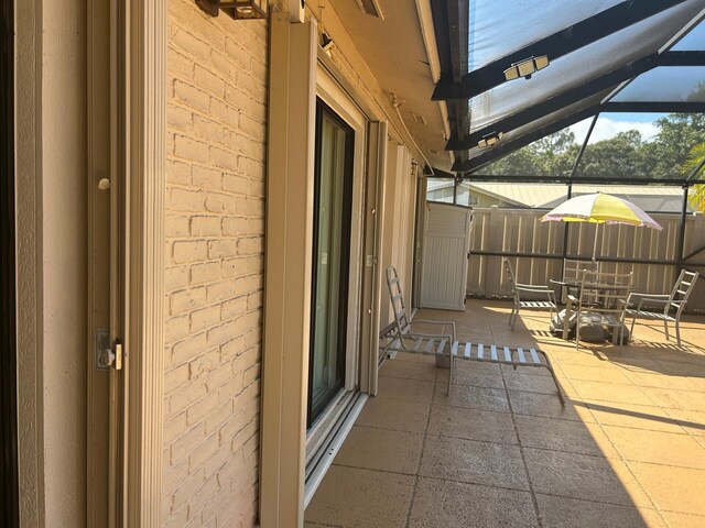 view of patio / terrace featuring a lanai