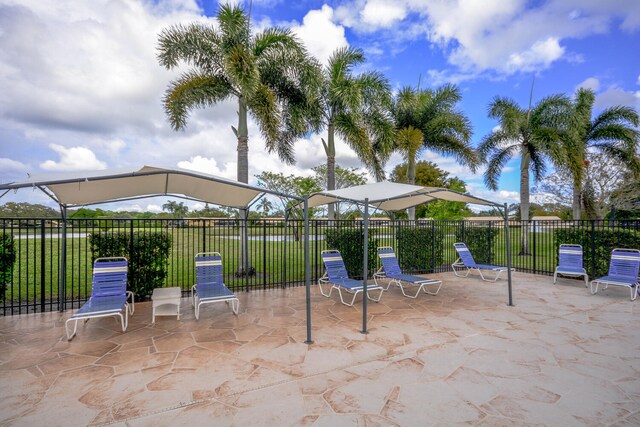 view of patio featuring a lanai