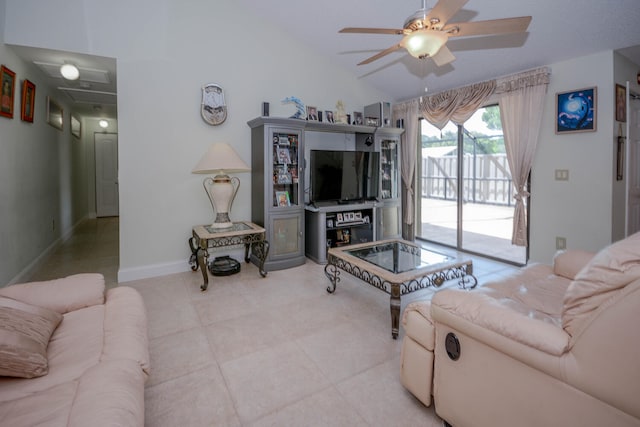 living area with a ceiling fan, lofted ceiling, baseboards, and light tile patterned floors