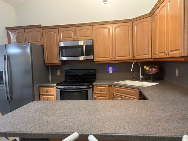 kitchen featuring stainless steel appliances, sink, and decorative backsplash