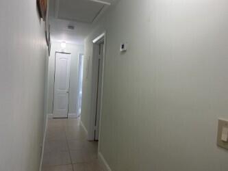 hallway featuring tile patterned flooring