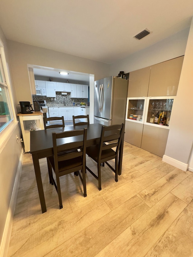 dining space featuring light wood-type flooring