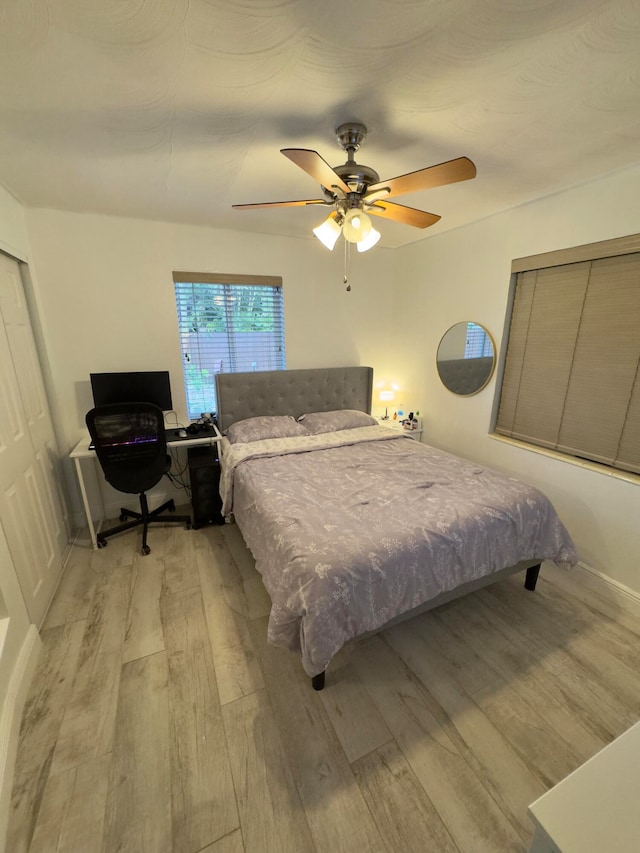 bedroom featuring ceiling fan and light hardwood / wood-style flooring