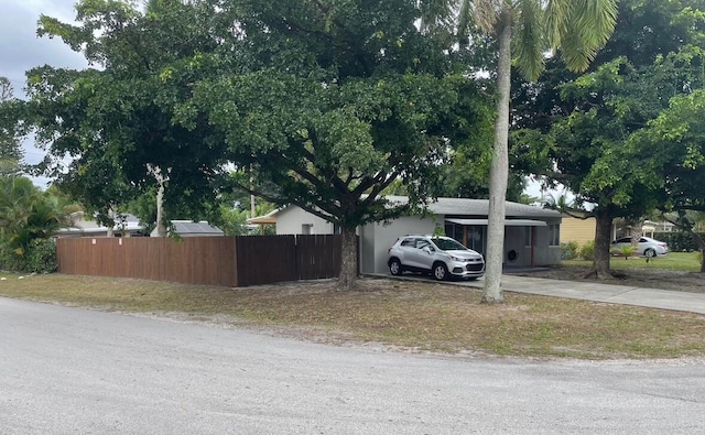 exterior space with driveway and fence