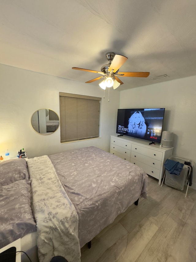 bedroom with light hardwood / wood-style floors and ceiling fan