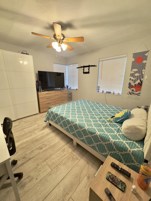 bedroom with ceiling fan and wood finished floors