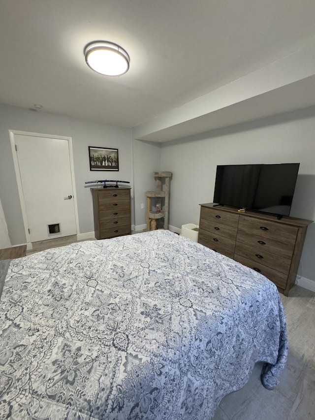 bedroom featuring wood finished floors and baseboards