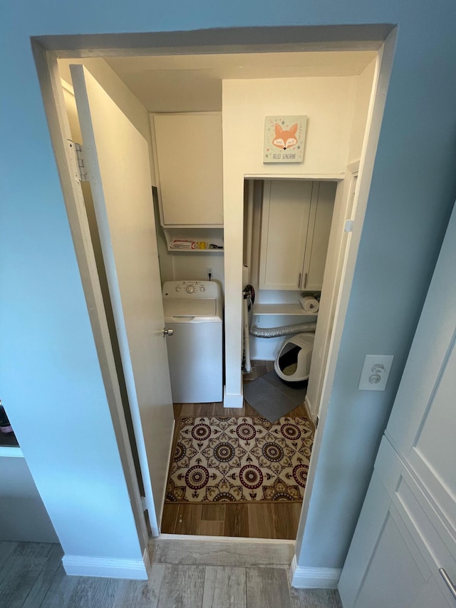 laundry room with washer / dryer, laundry area, baseboards, and wood finished floors