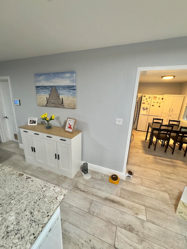 room details with dishwasher and hardwood / wood-style flooring