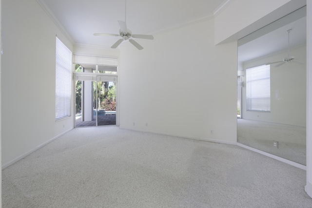 carpeted spare room with crown molding and ceiling fan