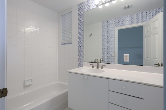 bathroom with vanity and tiled shower / bath