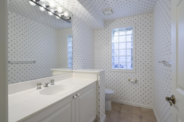 bathroom featuring tile patterned floors, vanity, and toilet