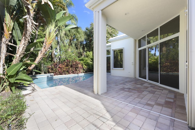 view of patio / terrace with a pool with hot tub