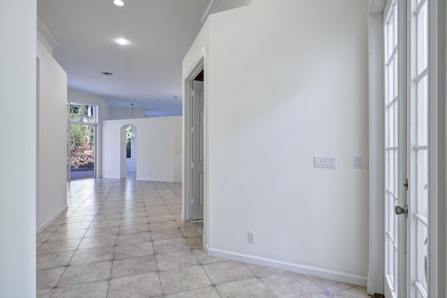 hall with light tile patterned floors