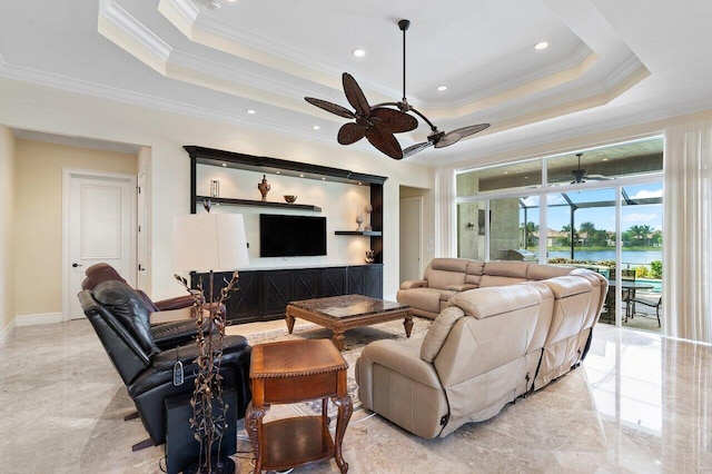 living room with a tray ceiling, ceiling fan, and ornamental molding