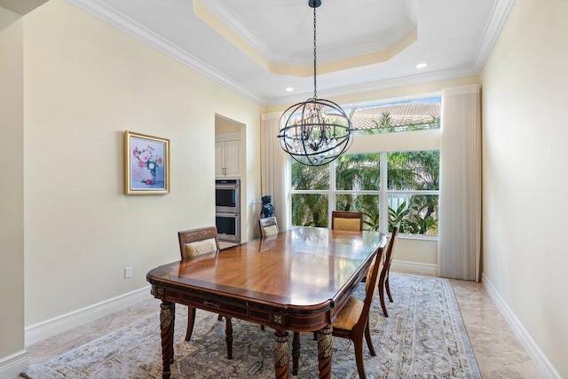 dining room featuring a tray ceiling, a notable chandelier, and ornamental molding