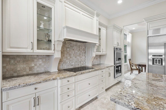 kitchen with backsplash, crown molding, white cabinets, and stainless steel appliances