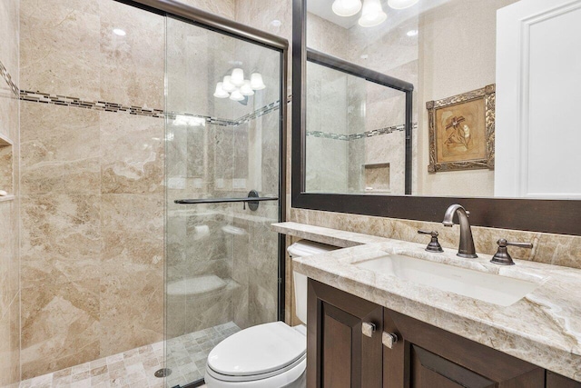 bathroom featuring walk in shower, vanity, and toilet