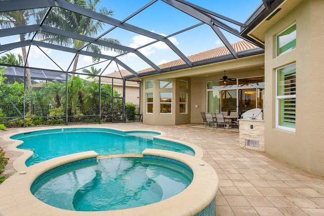 view of swimming pool with glass enclosure, an in ground hot tub, and a patio