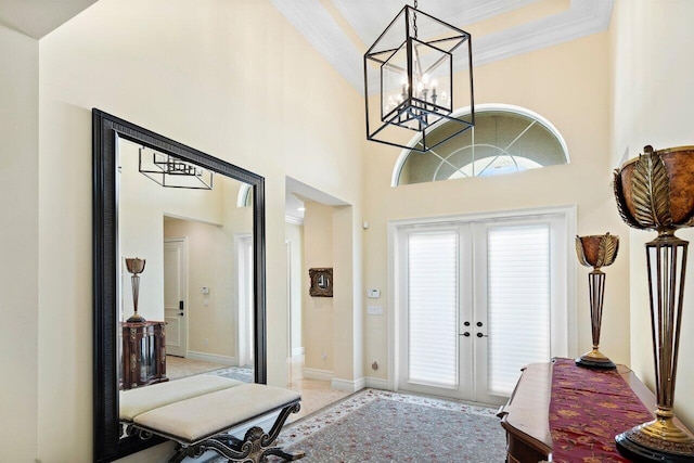 entrance foyer featuring crown molding, french doors, and a high ceiling