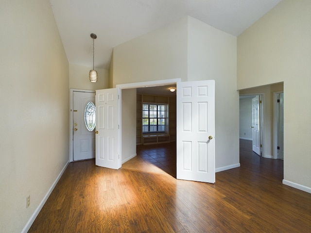 foyer featuring dark hardwood / wood-style floors and high vaulted ceiling