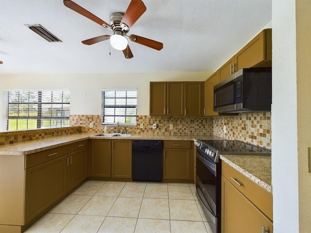 kitchen with tasteful backsplash, black appliances, sink, ceiling fan, and light tile patterned floors