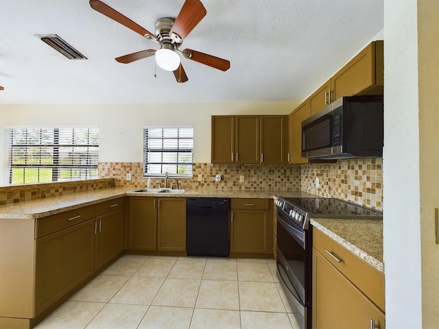 kitchen with light tile patterned floors, tasteful backsplash, visible vents, appliances with stainless steel finishes, and a sink