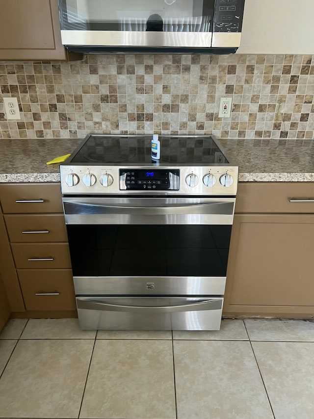 kitchen featuring stainless steel appliances, tasteful backsplash, and light tile patterned floors