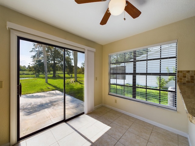 entryway featuring plenty of natural light, baseboards, and light tile patterned flooring