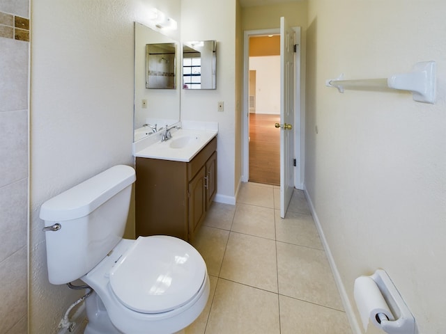 bathroom with vanity, toilet, and tile patterned floors