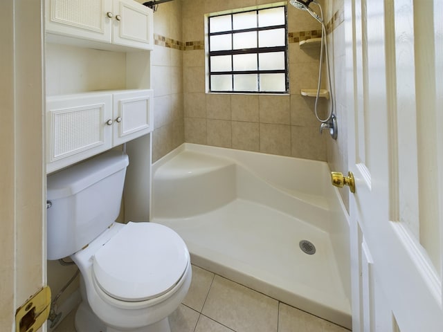 bathroom with toilet, plus walk in shower, and tile patterned flooring